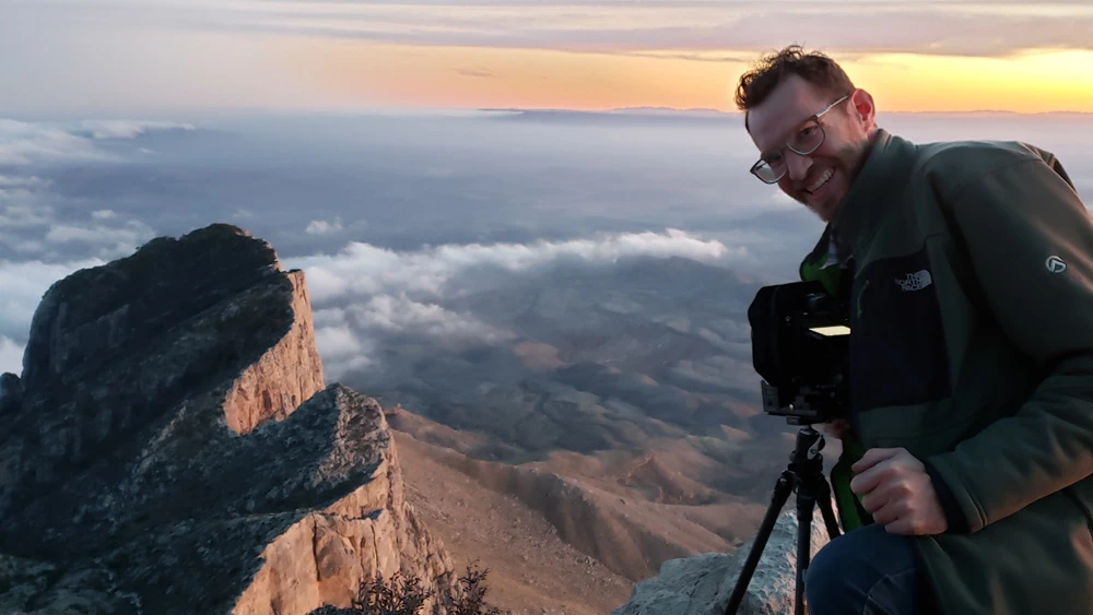 Photographer Tyler W. Green on top of Guadalupe Peak in West Texas